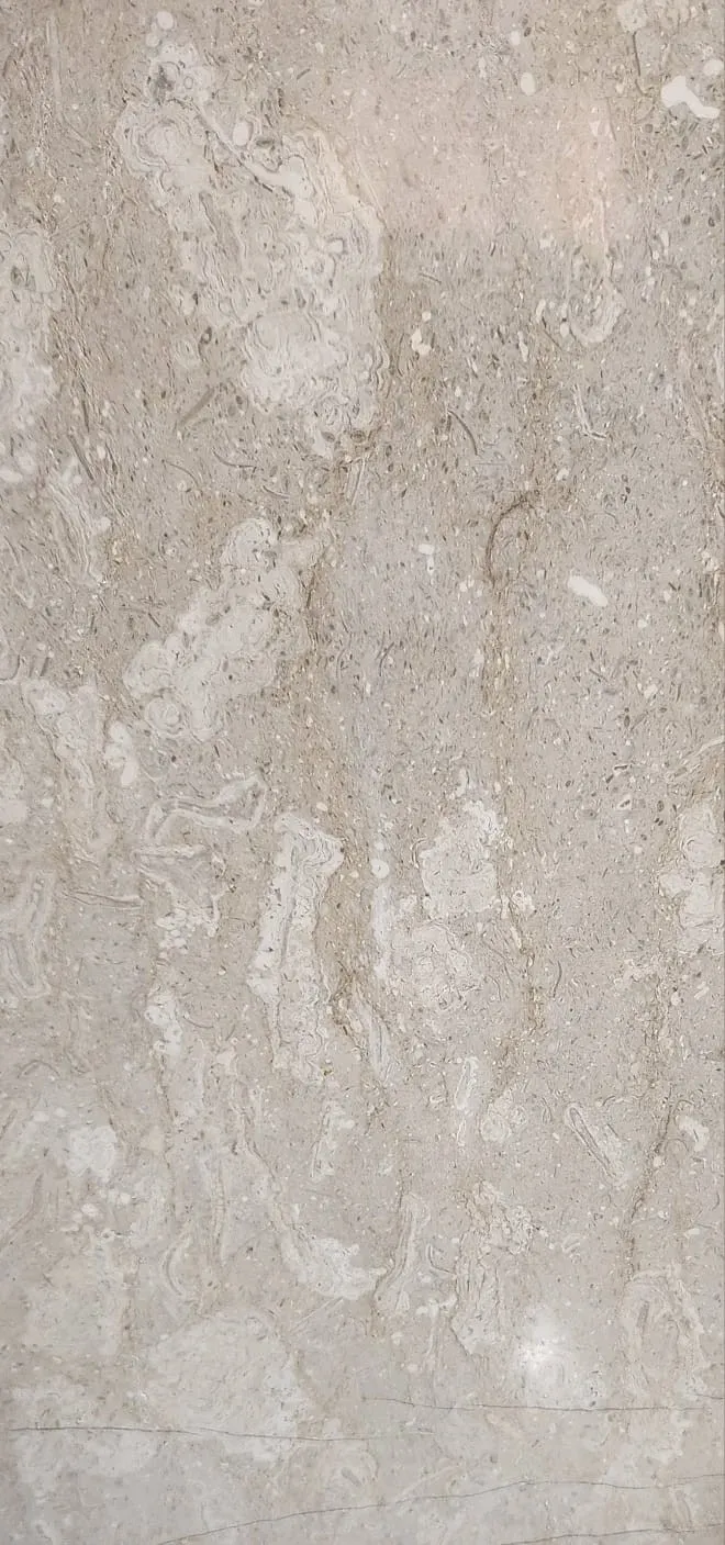 Polished slab of Tavera marble in gold tones